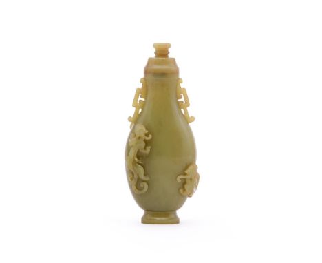 A Chinese celadon jade vase and cover, possibly Republic, of slender baluster shape, well carved with three chilong, archaic 