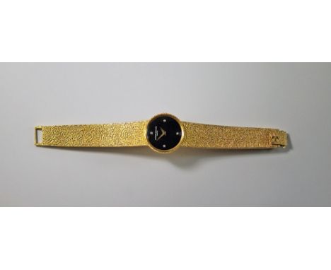 An 18ct gold Vacheron Constantin ladies wrist watch, with black dial and four brilliant cut diamonds to the compass points, i