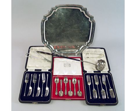 A silver salver, Sheffield 1964, Viner's Ltd, of square for, with shaped canted corners and stepped rim, raised on four coile