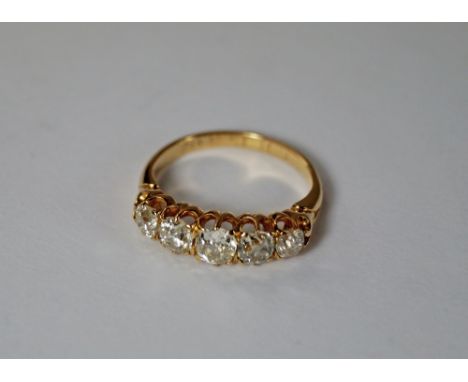 A five stone diamond ring, the yellow metal shank with engraved date 15.3.02, the claw set diamonds approx 1ct total, approx.