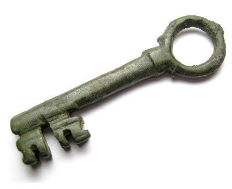 Medieval Door Key.  Circa 13th - 14th century AD. Size: 90.74 mm. A large bronze key with a circular bow, detailed with a kno