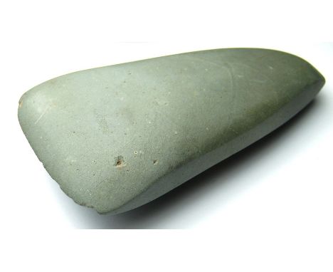 Neolithic polished greenstone axehead. A ground and polished Neolithic axehead c. 4000BC - 3000BC. The axe is trapezoidal in 