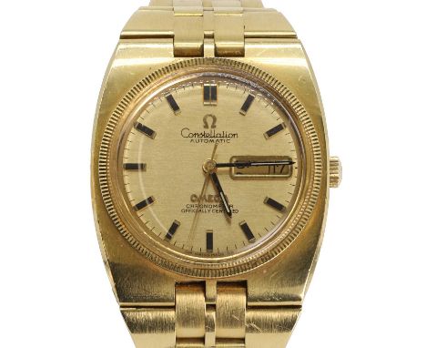 An 18ct gold Omega Constellation day-date automatic bracelet watch,  the tonneau form case with a gilt dial, raised enamelled