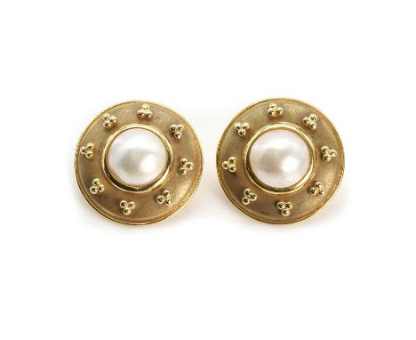 A pair of 18ct gold and mabé pearl disc shaped earrings, centrally set with a mabé pearl within a domed textured gold surroun