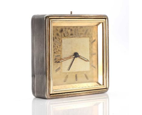A sterling silver and gold travel alarm clock, by Boucheron, of revolving hinged design, reeded silver case with polished gol