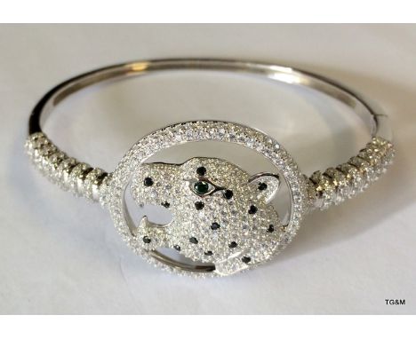 A Silver & CSU Bangle In The Form Of A Tiger Inset With Sapphires