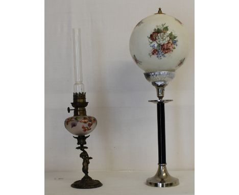 A brass oil lamp with glass globe shade and a 1950s' floor standing ashtray