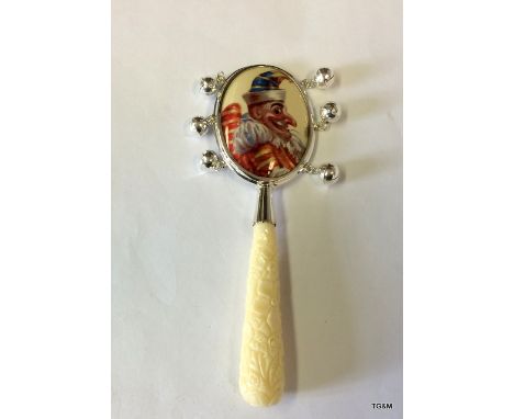 A Silver Babies Rattle With Enamel Plaque And Bone Handle