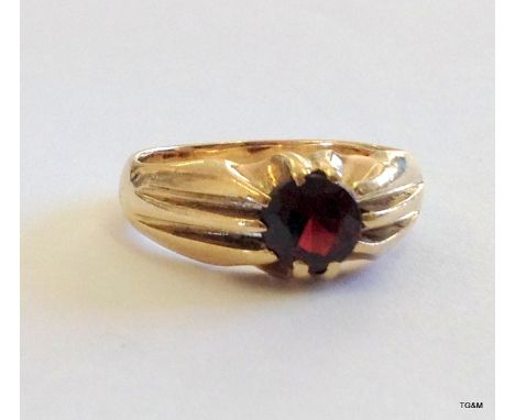 A 9ct gold mans signet ring with garnet stone size O