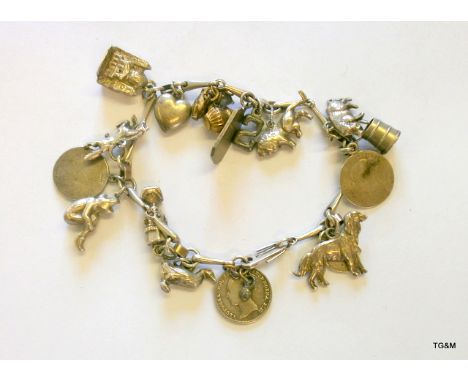 A silver charm bracelet with approx 20 charms