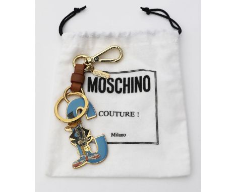 Schlüsselanhänger "Daffy Dack", Moschino. Emaillierter, in C-Form stillisierter Schlüßelanhänger aus Moschino's Looney Tools-