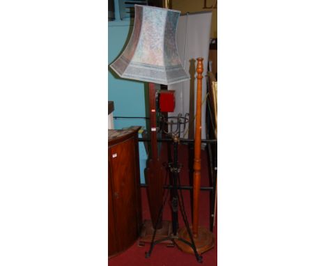 A turned beechwood lamp standard; an Art Deco lamp stand with shade; and a wrought iron telescopic oil lamp stand (lacking fi