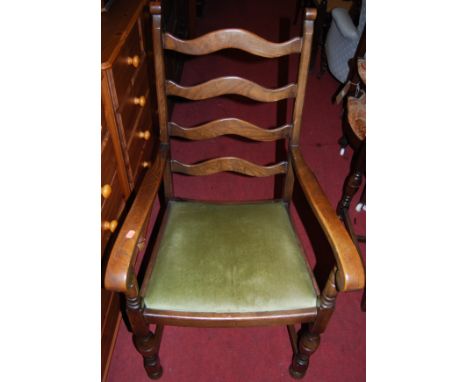 A set of six elm and oak ladder back dining chairs, each having green upholstered drop-in pad seats (4+2)