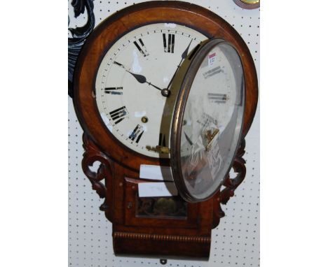 A Victorian figured walnut circular drop trunk wall clock, with pendulum and key
