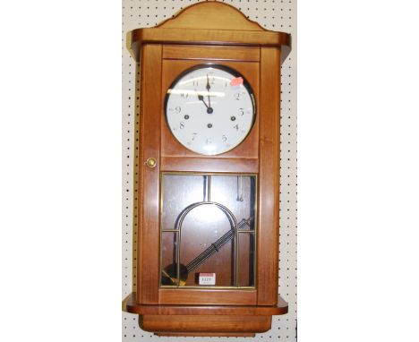A contemporary beech Lowell Westminster chime drop trunk wall clock, with pendulum and key