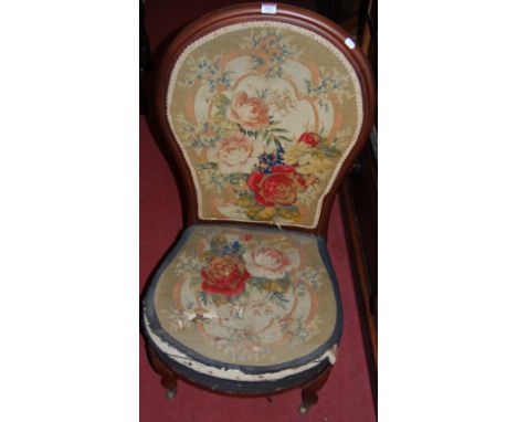 A Victorian mahogany framed and floral needlework tapestry upholstered nursing chair