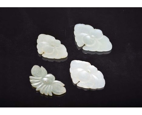 Four Chinese pale green jade pendants, late Qing DynastyEach carved as a stylised flower.5-6.5cm
