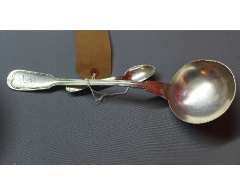 A large white metal ladle together with a white metal tea spoon stamped 800.