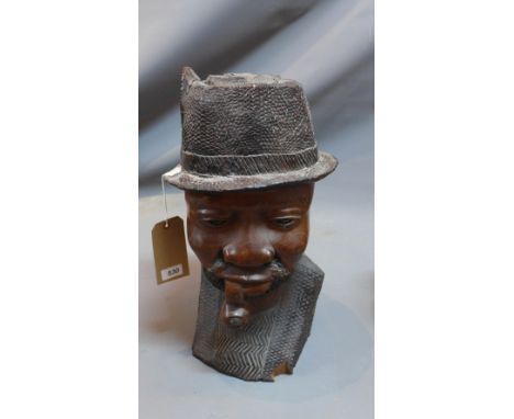 An African hardwood bust of a man smoking a pipe. H-50cm 