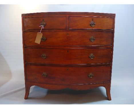 A Georgian mahogany bow fronted chest of drawers, having boxwood inlay, two short over three long drawers, over a shaped apro