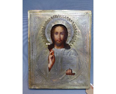 A Russian icon depicting Christ Pantocrator, painted wooden panel with silver oklad, hallmarked and bearing assay mark for An