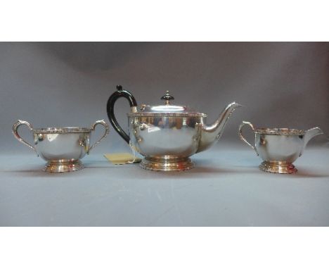 A Garrad & Co silver plated tea pot with ebonised handle and finial, together with a Garrad & Co milk jug and twin handled su