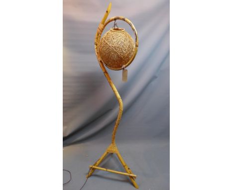 A 20th Century wicker standard lamp. 