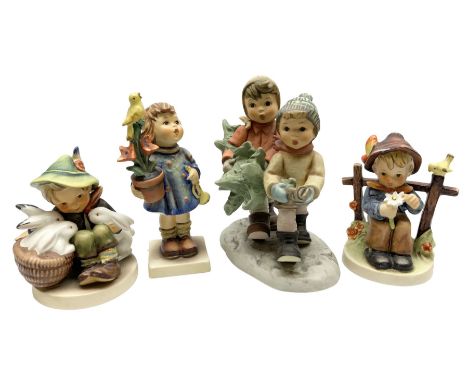 Four Goebel Hummel figures comprising Tree Trimming Time, She Loves me She Loves Me Not 174, Playmates 53/0, and Congratulati