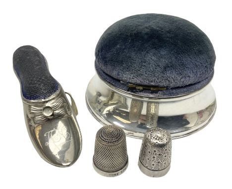 Silver mounted pin cushion, of circular form, together with two silver thimbles, and a base metal pin cushion with tape measu