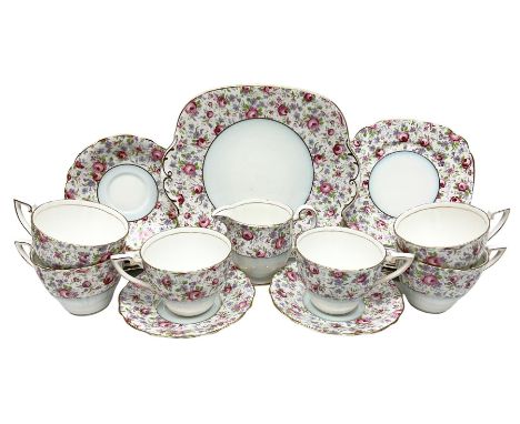 Windsor tea service for six decorated with blooming pink roses and purple flowers amongst foliage