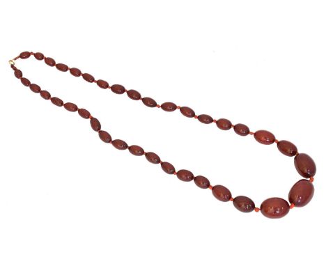 A cherry bakelite necklace,  A cherry bakelite necklace, the graduated oval cherry amber bakelite beads with a spring clasp, 