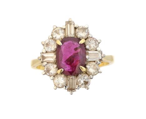 An 18ct gold ruby and diamond cluster ring, An 18ct gold ruby and diamond cluster ring, the oval shape ruby weighing approx. 