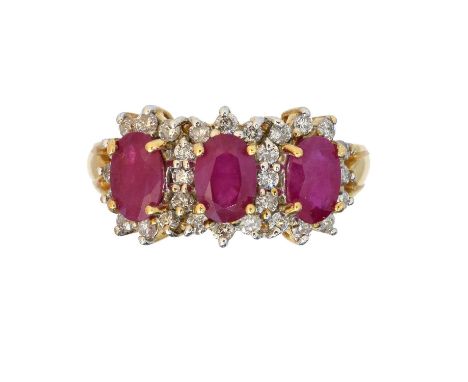 An 18ct gold ruby and diamond cluster ring,  An 18ct gold ruby and diamond cluster ring, the oval shape ruby line within a sh