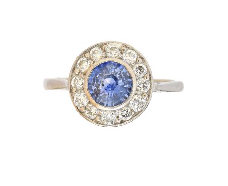 A sapphire and diamond cluster ring, A sapphire and diamond cluster ring, the circular shape sapphire within a brilliant cut 