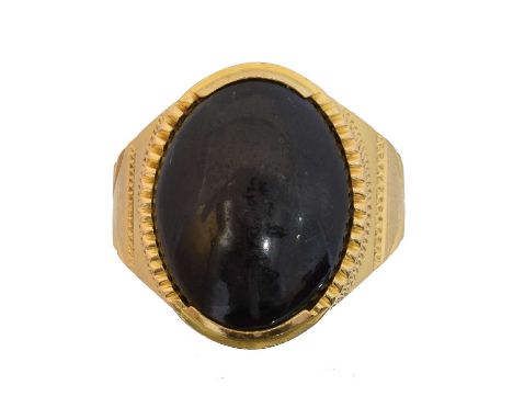 An onyx dress ring, An onyx dress ring, the oval onyx cabochon with tapered shoulders, stamped 22K, ring size R, gross weight