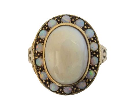 A 9ct gold opal poison ring, A 9ct gold opal poison ring, the cabochon opal cluster opening to reveal a vacant compartment, h