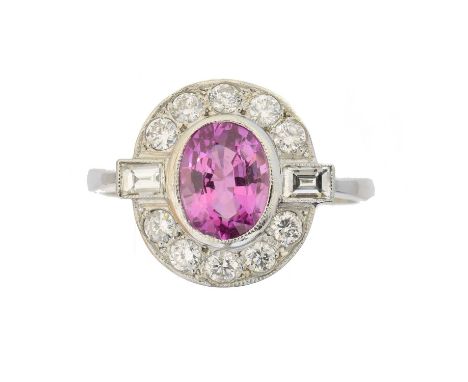 A sapphire and diamond cluster ring, A sapphire and diamond cluster ring, the oval shape pink sapphire weighing approx. 1.35c