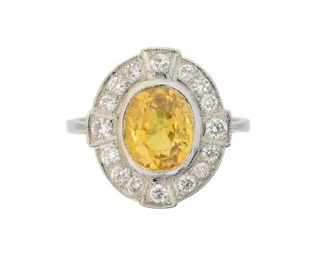 A sapphire and diamond cluster ring,  A sapphire and diamond cluster ring, the oval shape yellow sapphire weighing approx. 2.