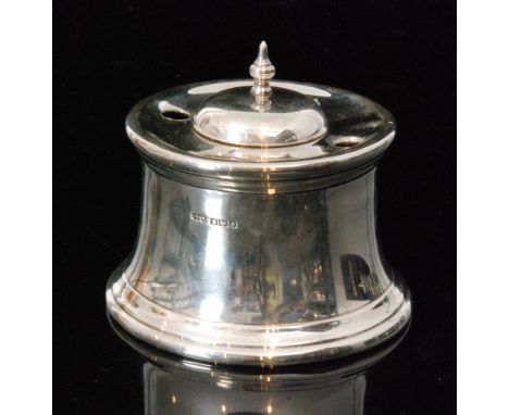 An Edwardian hallmarked silver cylindrical desk inkwell, the central well with hinged domed cover surrounded by four circular
