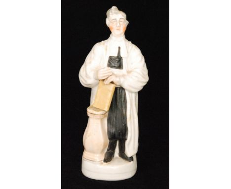 A 19th Century Staffordshire portrait figure of Revd. Thomas Raffles stood beside a pedestal with a book in his hand, unmarke