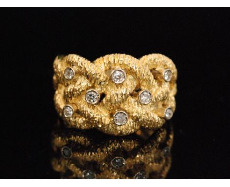 A modern 18ct hallmarked diamond ring the intertwined bark effect head set with eight individually collar set brilliant cut s
