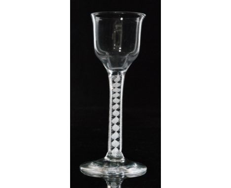 An 18th Century drinking glass circa 1765, lipped ogee bowl above a double series opaque twist stem with four ply spiral outs