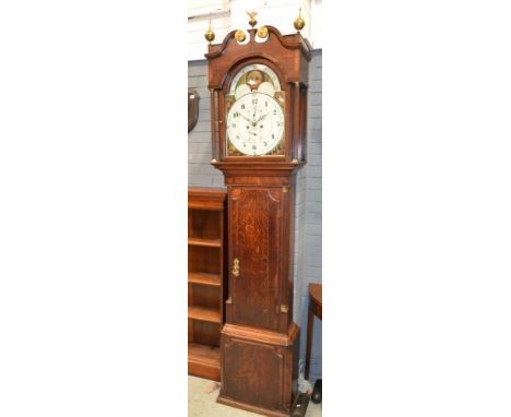 A 19th Century oak and mahogany crossbanded longcase clock with twin swan neck pediment, the eight day movement striking on a