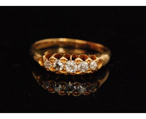 An early 20th Century 18ct graduated five stone diamond boat shaped ring, claw set old cut stones, ring size K 1/2. 