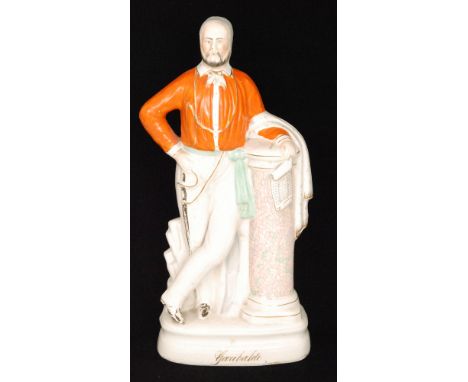 A large 19th Century Staffordshire portrait figure of Garibaldi, he stood leaning against a faux marble pedestal and holding 