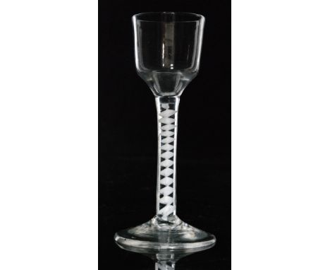 An 18th Century drinking glass circa 1765, ogee bowl above a single series opaque twist stem with a multi ply corkscrew, rais