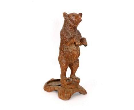 A late 19th to early 20th Century Black Forest carved wood umbrella or stick stand in the form of a standing bear on a natura