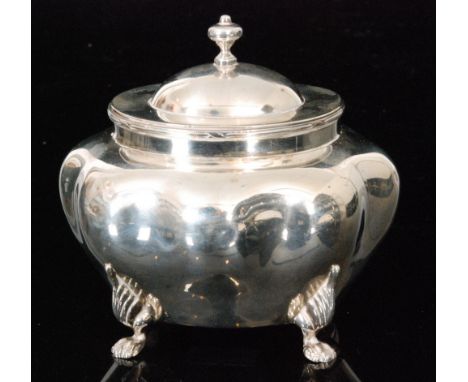 A hallmarked silver tea caddy of shaped oval outline with hinged cover and raised on on four lions paw feet, weight 4.5oz, Bi