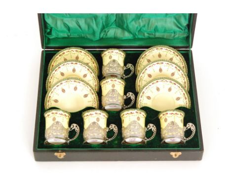 An early 20th Century cased Royal Worcester coffee set comprising six cans and six saucers each decorated with a garland and 