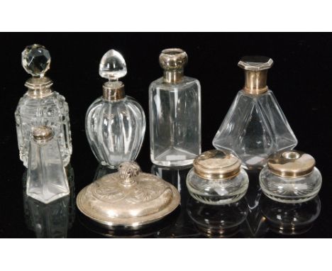 A collection of seven silver mounted dressing table bottles and jars, various dates and makers and a hallmarked silver circul